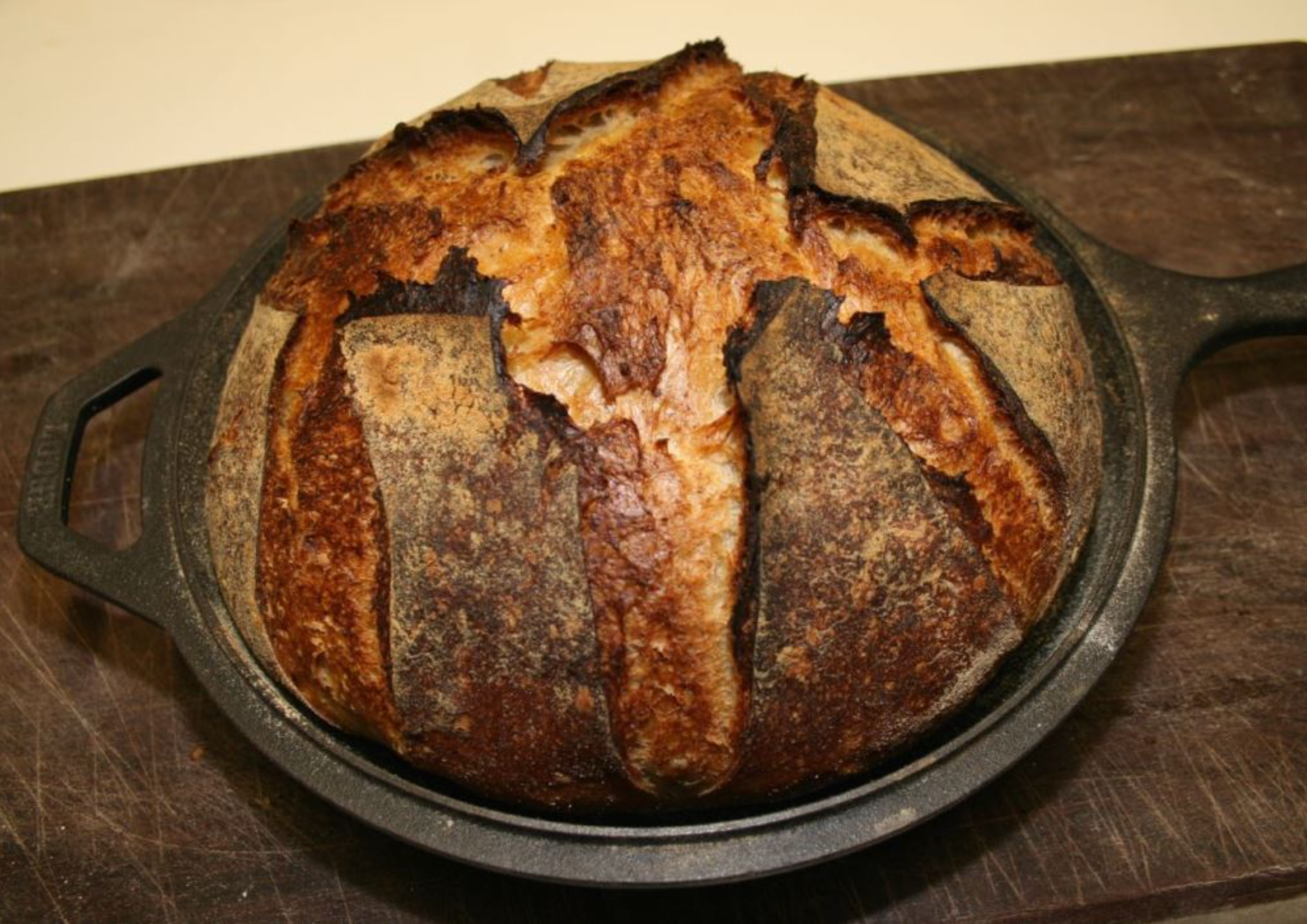 Roasted garlic asiago sourdough. Made in a Lodge Dutch oven and a Cabela's  combo cooker. : r/castiron